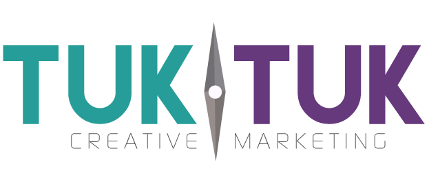 The logo for TukTuk Creative Marketing, which features prominently the words "TUK TUK" in a bold font in all capitals. The first "TUK" is in a turquoise font and the second in a deep purple font. They are separated by a compass needle pointing north to south. The words "CREATIVE MARKETING" sit below in light grey font.